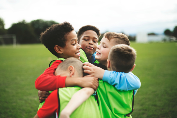 childrens football team, group hug