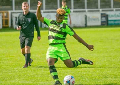 Kray Foster, professional football coach, on pitch kicking football