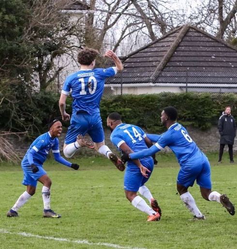 Kray Foster, playing football game with current clients, cheering on pitch