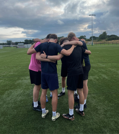 Kray Fosters football coaching, group huddle